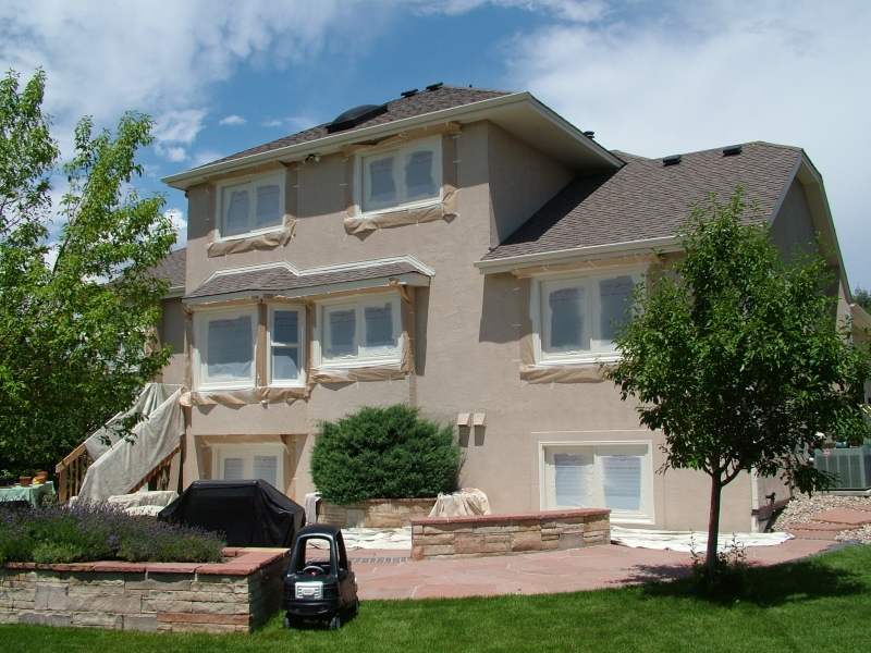 Painting windows on the stucco house